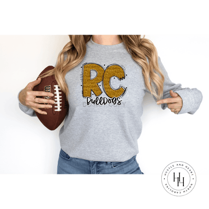 Rc Bulldogs Old Gold Glitter Varsity Doodle Graphic Tee Unisex Tee